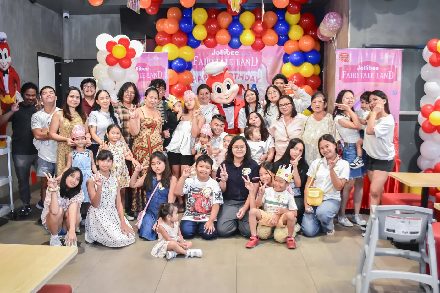 Big group photo of birthday guests with a mascot, event coverage by Dana Shotz in Cavite