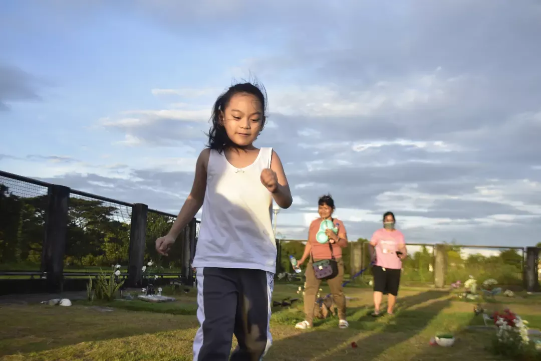 Girl running on a grass path at sunset, outdoor photography in Cavite